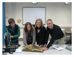 Dr Esti Eshel, Prof. Daniel Falk, and Dr. Dorothy Peters studying a Cairo Genizah manuscript.